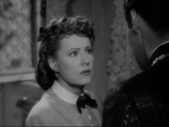 Movie still from “Anna and the King of Siam” (1946), directed by John Cromwell – An old photo of a woman with a bow in her hair; Close Up shot, Over the shoulder angle