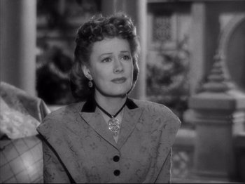 Movie still from “Anna and the King of Siam” (1946), directed by John Cromwell – An old photo of a woman looking at the camera; Close Up shot, Over the shoulder angle