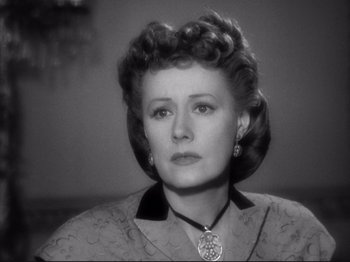 Movie still from “Anna and the King of Siam” (1946), directed by John Cromwell – An old photo of an older woman with a necklace; Close Up shot, Low angle