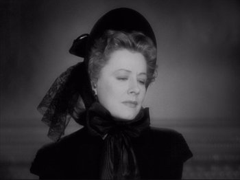 Movie still from “Anna and the King of Siam” (1946), directed by John Cromwell – An old photo of a woman wearing a black hat; Close Up shot, Low angle