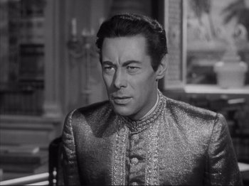 Movie still from “Anna and the King of Siam” (1946), directed by John Cromwell – A black and white photo of a man in a suit; Close Up shot, High angle