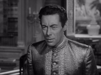 Movie still from “Anna and the King of Siam” (1946), directed by John Cromwell – A black and white photo of a man in a suit; Close Up shot, High angle