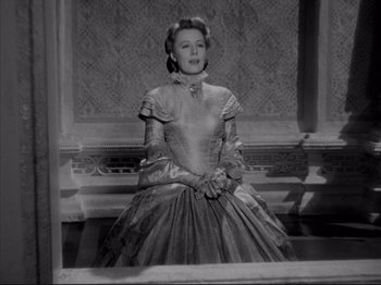 Movie still from “Anna and the King of Siam” (1946), directed by John Cromwell – An old black and white photo of a woman in a dress; Medium shot, Low angle