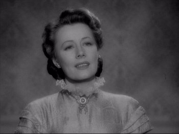 Movie still from “Anna and the King of Siam” (1946), directed by John Cromwell – An old photo of a woman in a white dress; Close Up shot, Low angle