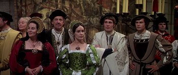 Movie still from “Anne of the Thousand Days” (1969), directed by Charles Jarrott – A group of men and women dressed in medieval clothing; Medium shot, High angle