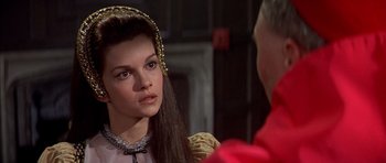Movie still from “Anne of the Thousand Days” (1969), directed by Charles Jarrott – A young woman wearing a gold headpiece looks at an older man; Close Up shot, Over the shoulder angle