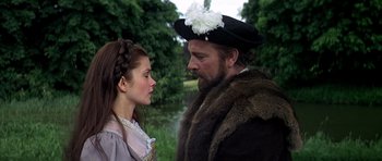 Movie still from “Anne of the Thousand Days” (1969), directed by Charles Jarrott – A man and a woman standing next to each other in front of a body of water; Close Up shot, Over the shoulder angle
