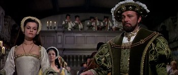 Movie still from “Anne of the Thousand Days” (1969), directed by Charles Jarrott – A group of people dressed in renaissance costumes; Medium shot, Over the shoulder angle