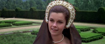 Movie still from “Anne of the Thousand Days” (1969), directed by Charles Jarrott – A woman wearing a headdress and a necklace; Close Up shot, Over the shoulder angle