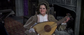 Movie still from “Anne of the Thousand Days” (1969), directed by Charles Jarrott – A woman dressed in medieval clothing holding a lute; Medium shot, High angle