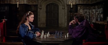 Movie still from “Anne of the Thousand Days” (1969), directed by Charles Jarrott – Two people sitting at a table playing a game of chess; Medium shot, High angle