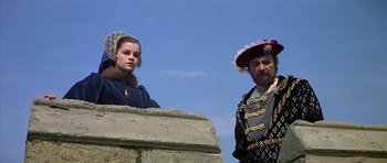 Movie still from “Anne of the Thousand Days” (1969), directed by Charles Jarrott – A man and a woman standing next to each other; Medium shot, Low angle