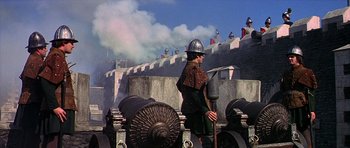 Movie still from “Anne of the Thousand Days” (1969), directed by Charles Jarrott – A man wearing a helmet and holding an axe; Wide shot, Low angle