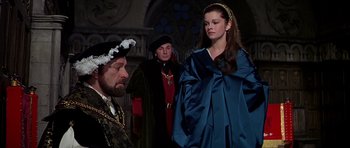 Movie still from “Anne of the Thousand Days” (1969), directed by Charles Jarrott – A man and two women dressed in medieval garb; Medium shot, Over the shoulder angle