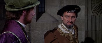 Movie still from “Anne of the Thousand Days” (1969), directed by Charles Jarrott – Two men in medieval garb talking to each other; Close Up shot, Over the shoulder angle