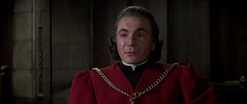 Movie still from “Anne of the Thousand Days” (1969), directed by Charles Jarrott – A person wearing a red robe; Close Up shot, Over the shoulder angle