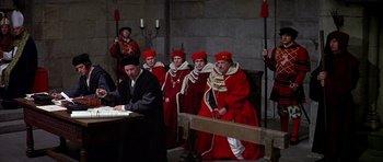 Movie still from “Anne of the Thousand Days” (1969), directed by Charles Jarrott – A group of men dressed in medieval clothing; Wide shot, High angle