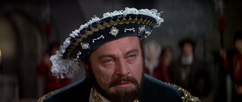 Movie still from “Anne of the Thousand Days” (1969), directed by Charles Jarrott – A person wearing a hat; Close Up shot, Over the shoulder angle