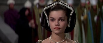 Movie still from “Anne of the Thousand Days” (1969), directed by Charles Jarrott – A young woman wearing pearls in a renaissance costume; Close Up shot, High angle