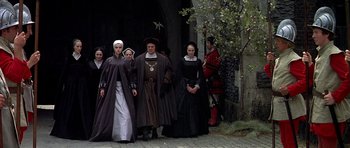 Movie still from “Anne of the Thousand Days” (1969), directed by Charles Jarrott – A group of people dressed in medieval clothing; Wide shot, High angle