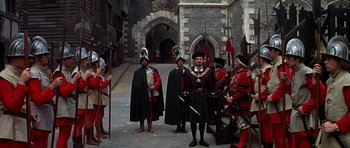 Movie still from “Anne of the Thousand Days” (1969), directed by Charles Jarrott – A group of men dressed in medieval costumes; Wide shot, High angle