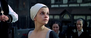Movie still from “Anne of the Thousand Days” (1969), directed by Charles Jarrott – A woman with a white head covering looking up; Close Up shot, Low angle