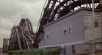 Movie still from “Annie Hall” (1977), directed by Woody Allen – A building with a roller coaster in the background; Extreme Wide shot, High angle