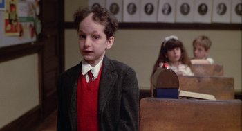 Movie still from “Annie Hall” (1977), directed by Woody Allen – A boy in a suit and tie standing in front of a girl; Close Up shot, Over the shoulder angle