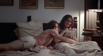 Movie still from “Annie Hall” (1977), directed by Woody Allen – A man and a woman reading a newspaper in a bed; Medium shot, High angle