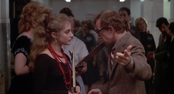 Movie still from “Annie Hall” (1977), directed by Woody Allen – A man and a woman in a crowd of people; Medium shot, Over the shoulder angle