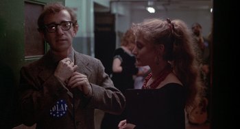 Movie still from “Annie Hall” (1977), directed by Woody Allen – A man and a woman standing next to each other in a room; Medium shot, Over the shoulder angle