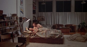 Movie still from “Annie Hall” (1977), directed by Woody Allen – A man and a woman laying on a bed; Wide shot, High angle