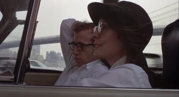 Movie still from “Annie Hall” (1977), directed by Woody Allen – A man and a woman sitting in the back of a car; Close Up shot, Over the shoulder angle