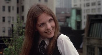 Movie still from “Annie Hall” (1977), directed by Woody Allen – A woman with long hair wearing a vest and a tie; Close Up shot, Over the shoulder angle