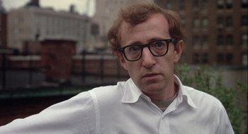 Movie still from “Annie Hall” (1977), directed by Woody Allen – A person wearing a white shirt and glasses; Close Up shot, Over the shoulder angle