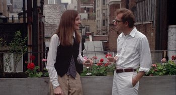 Movie still from “Annie Hall” (1977), directed by Woody Allen – A man and a woman are talking on a balcony; Medium shot, Low angle
