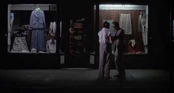 Movie still from “Annie Hall” (1977), directed by Woody Allen – A man and a woman standing in front of a clothing store; Wide shot, Over the shoulder angle