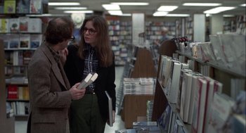 Movie still from “Annie Hall” (1977), directed by Woody Allen – Two people are looking at books in a store; Medium shot, Over the shoulder angle