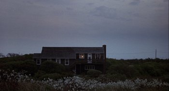 Movie still from “Annie Hall” (1977), directed by Woody Allen – A house that has a window lit up at night; Extreme Wide shot, High angle