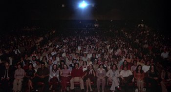Movie still from “Annie Hall” (1977), directed by Woody Allen – A large group of people sitting in front of a projector; Extreme Wide shot, High angle