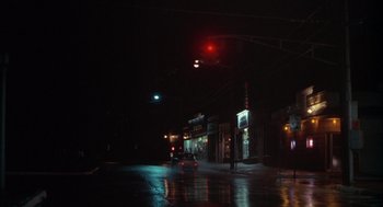 Movie still from “Annie Hall” (1977), directed by Woody Allen – A car driving down a street at night; Extreme Wide shot, High angle
