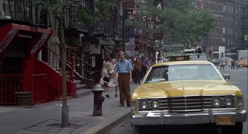 Movie still from “Annie Hall” (1977), directed by Woody Allen – A man and a woman walking down the sidewalk; Wide shot, Over the shoulder angle