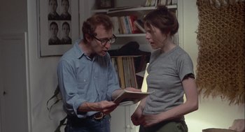 Movie still from “Annie Hall” (1977), directed by Woody Allen – A man and a woman are looking at a book; Medium shot, Over the shoulder angle
