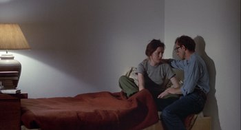 Movie still from “Annie Hall” (1977), directed by Woody Allen – A man and a woman sitting on a bed talking; Medium shot, High angle