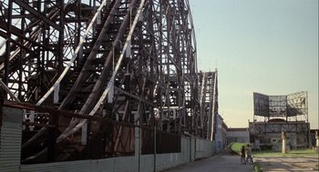 Movie still from “Annie Hall” (1977), directed by Woody Allen – A wooden structure that is being built on the side of the road; Extreme Wide shot, Low angle