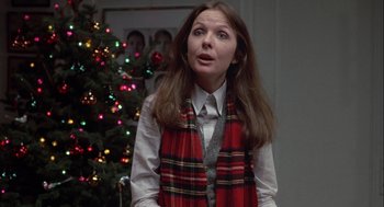 Movie still from “Annie Hall” (1977), directed by Woody Allen – A woman wearing a plaid vest standing in front of a christmas tree; Medium shot, Low angle