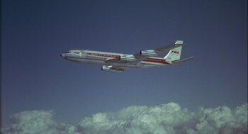 Movie still from “Annie Hall” (1977), directed by Woody Allen – An airplane is flying in the sky above the clouds; Extreme Wide shot, Low angle