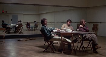 Movie still from “Annie Hall” (1977), directed by Woody Allen – A group of people sitting around a table; Wide shot, Low angle
