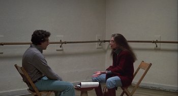 Movie still from “Annie Hall” (1977), directed by Woody Allen – A man and a woman are sitting in a room talking; Wide shot, Over the shoulder angle