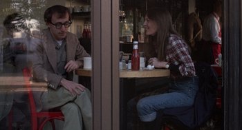 Movie still from “Annie Hall” (1977), directed by Woody Allen – A man and a woman are sitting at a table; Medium shot, Over the shoulder angle